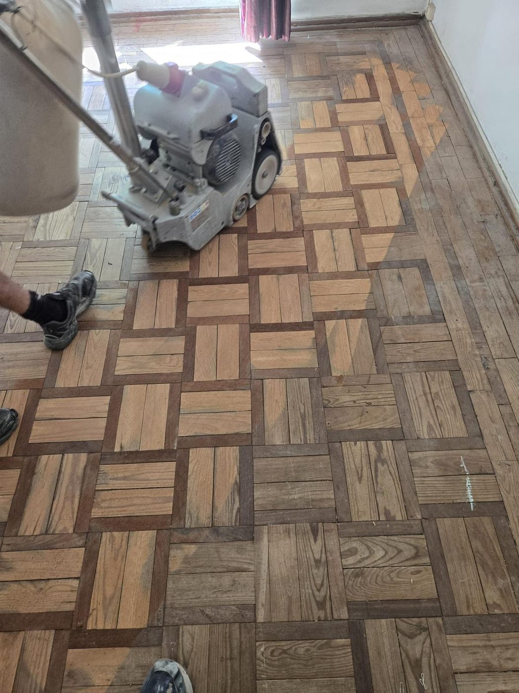 Soalho mosaico antes da renovação: tons irregulares, verniz desgastado, lixagem com máquina profissional